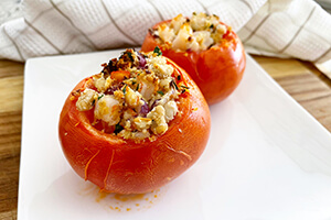 white bean and shrimp stuffed tomatoes on a plate
