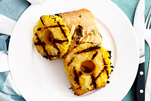 Grilled salmon with grilled pineapple on a plate